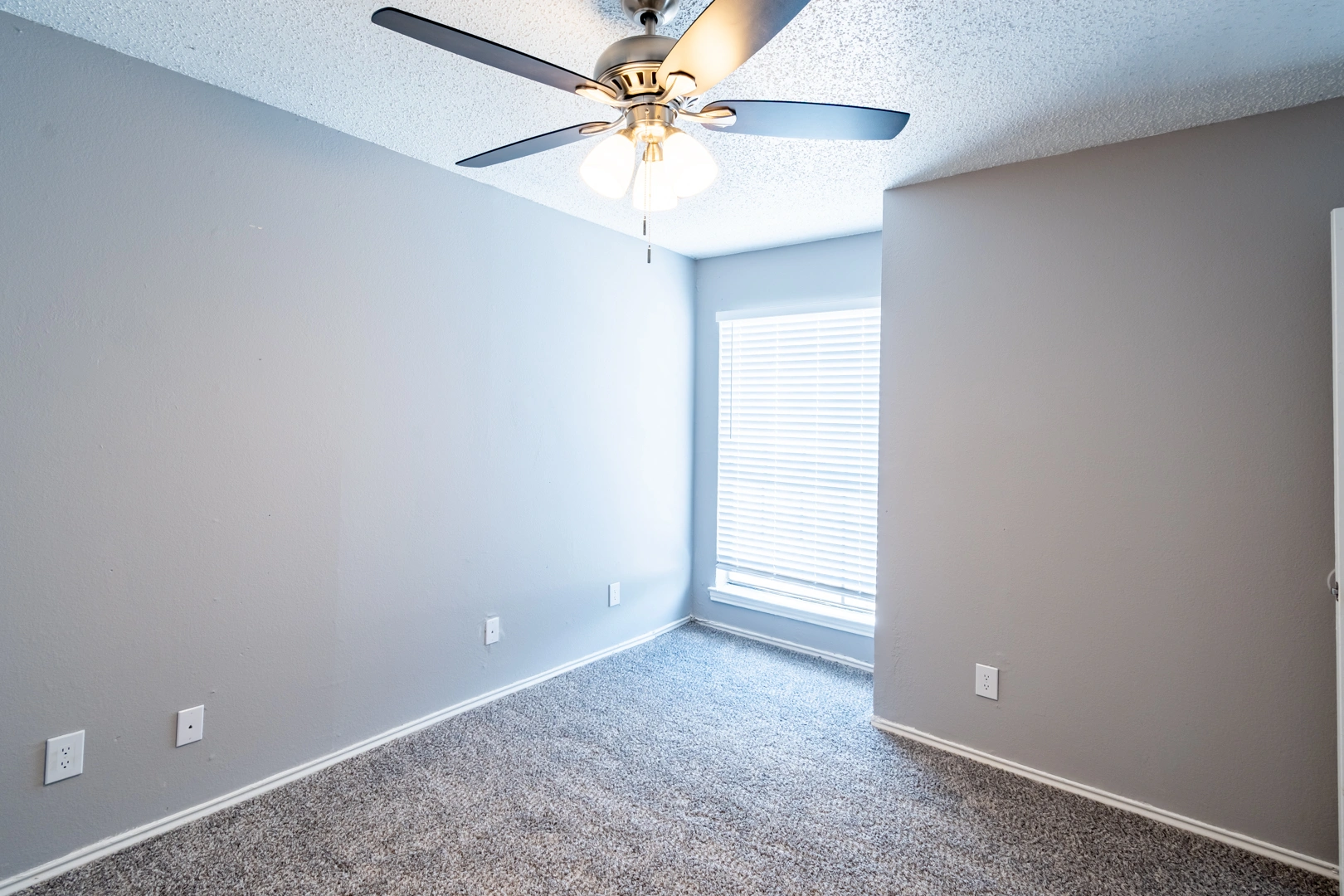 Sunlit secondary bedroom at La Prada Place Apartment Homes