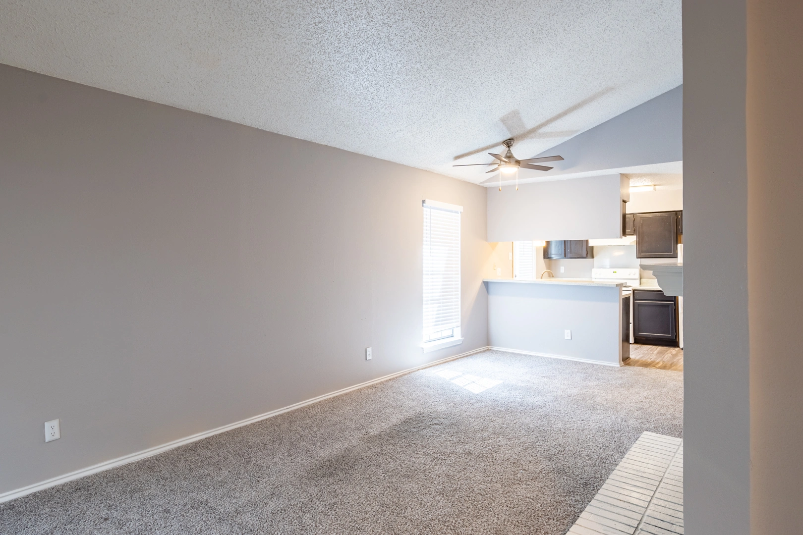 Townhome living area and kitchen pass at La Prada Place Apartment Homes