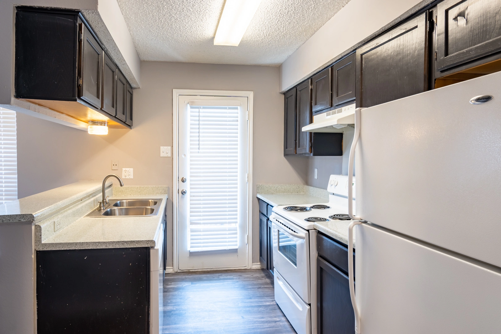 Kitchen layout and patio door at La Prada Place Apartment Homes