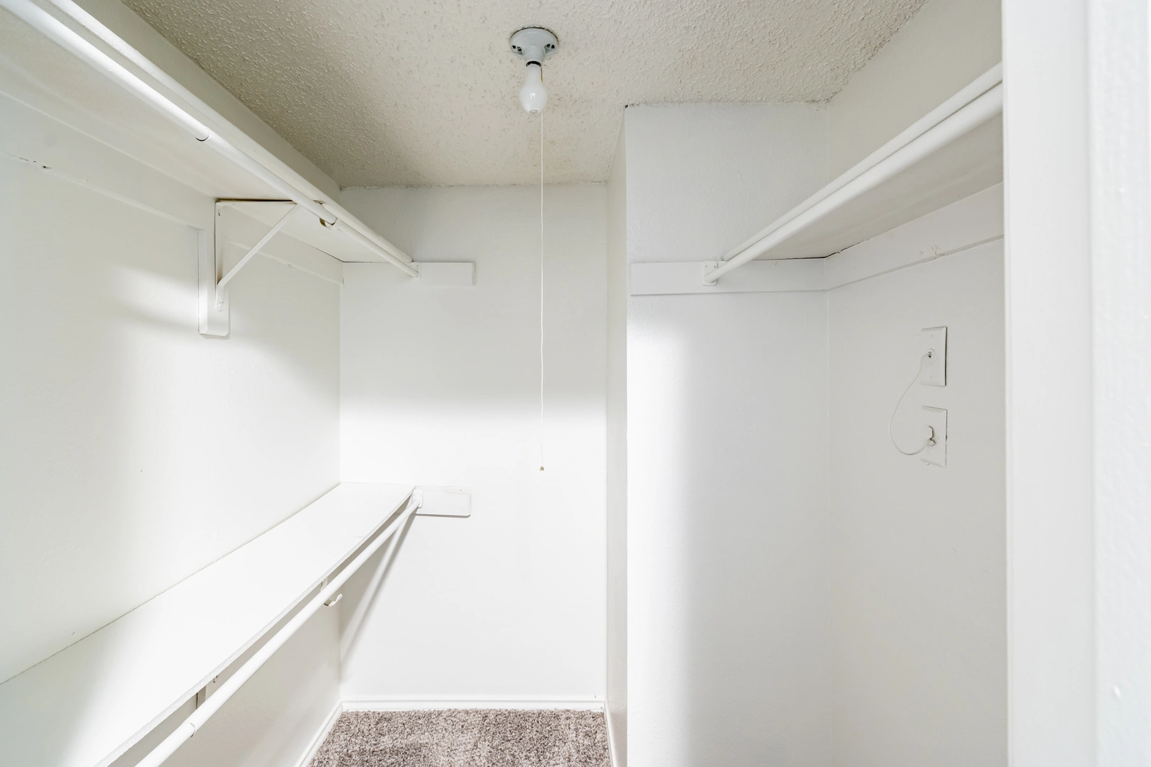 Walk-in closet with built-in shelving at La Prada Place Apartment Homes
