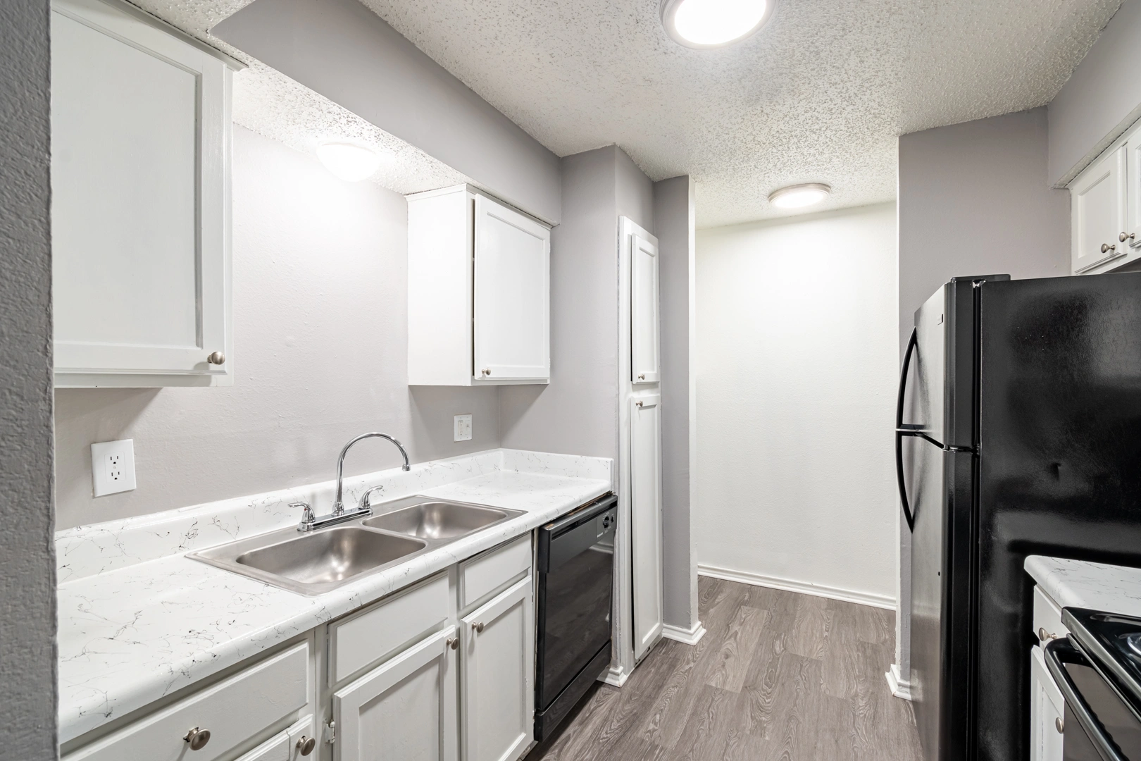 Kitchen double sink and counters at La Prada Place Apartment Homes