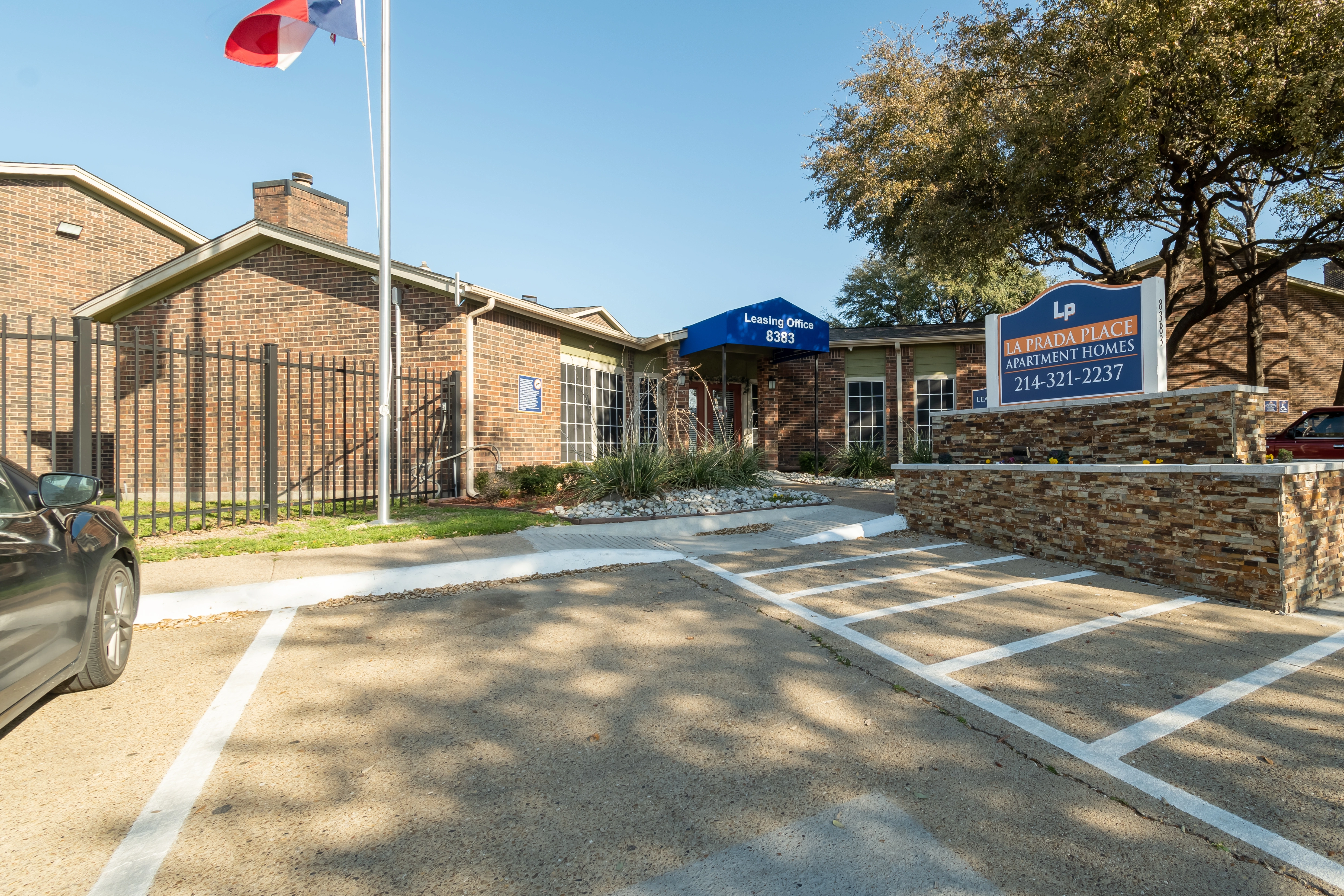 Parking lot and community entry at La Prada Place Apartment Homes