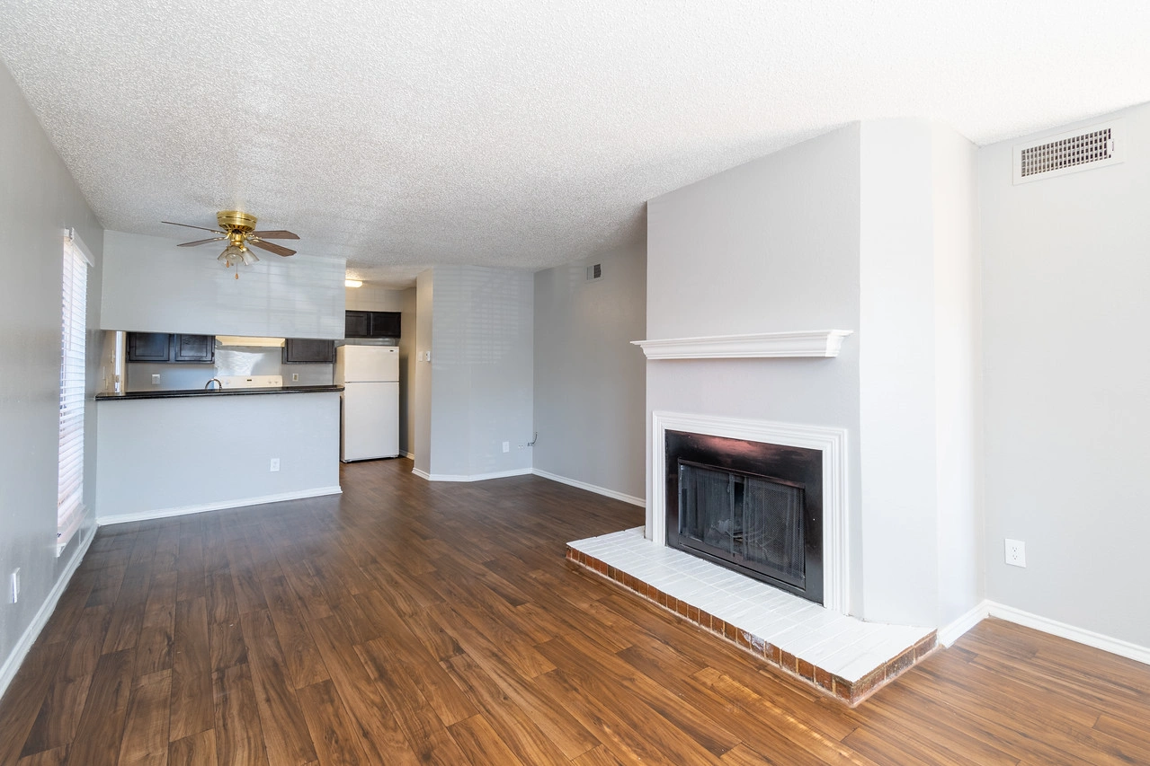 Living room with fireplace at La Prada Place Apartment Homes