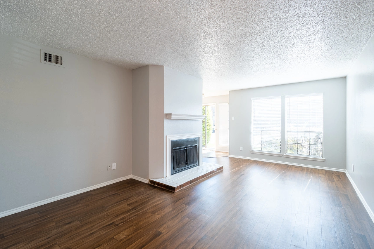 Living area with picture windows at La Prada Place Apartment Homes