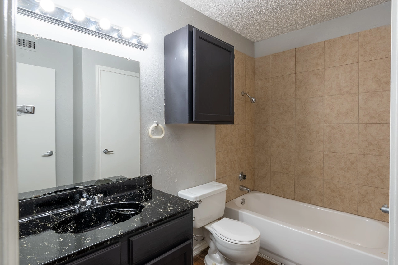 Modern bathroom vanity and tub at La Prada Place Apartment Homes