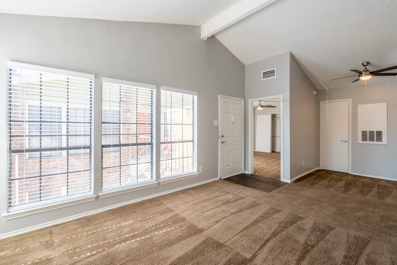 Open living area with picture window at La Prada Place Apartment Homes