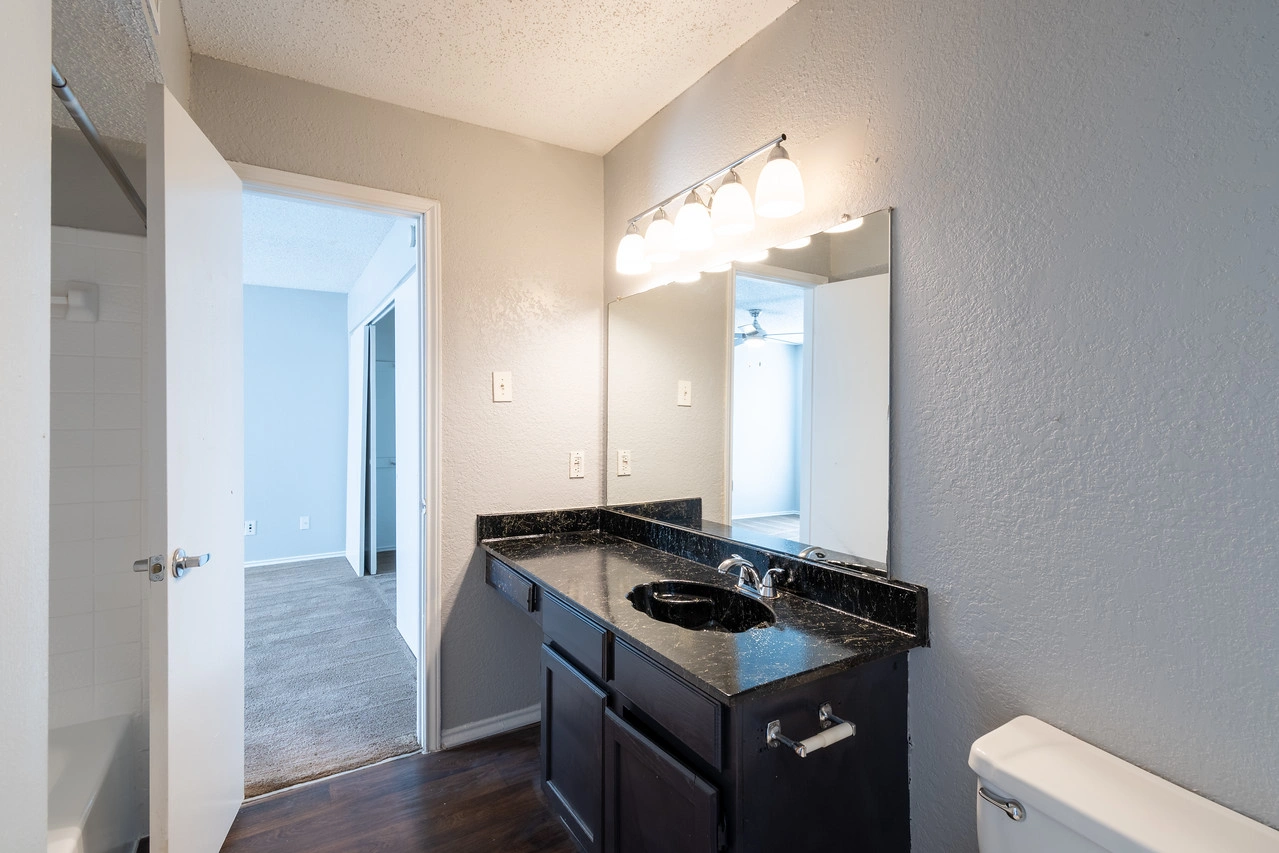 Modern vanity and linen storage at La Prada Place Apartment Homes